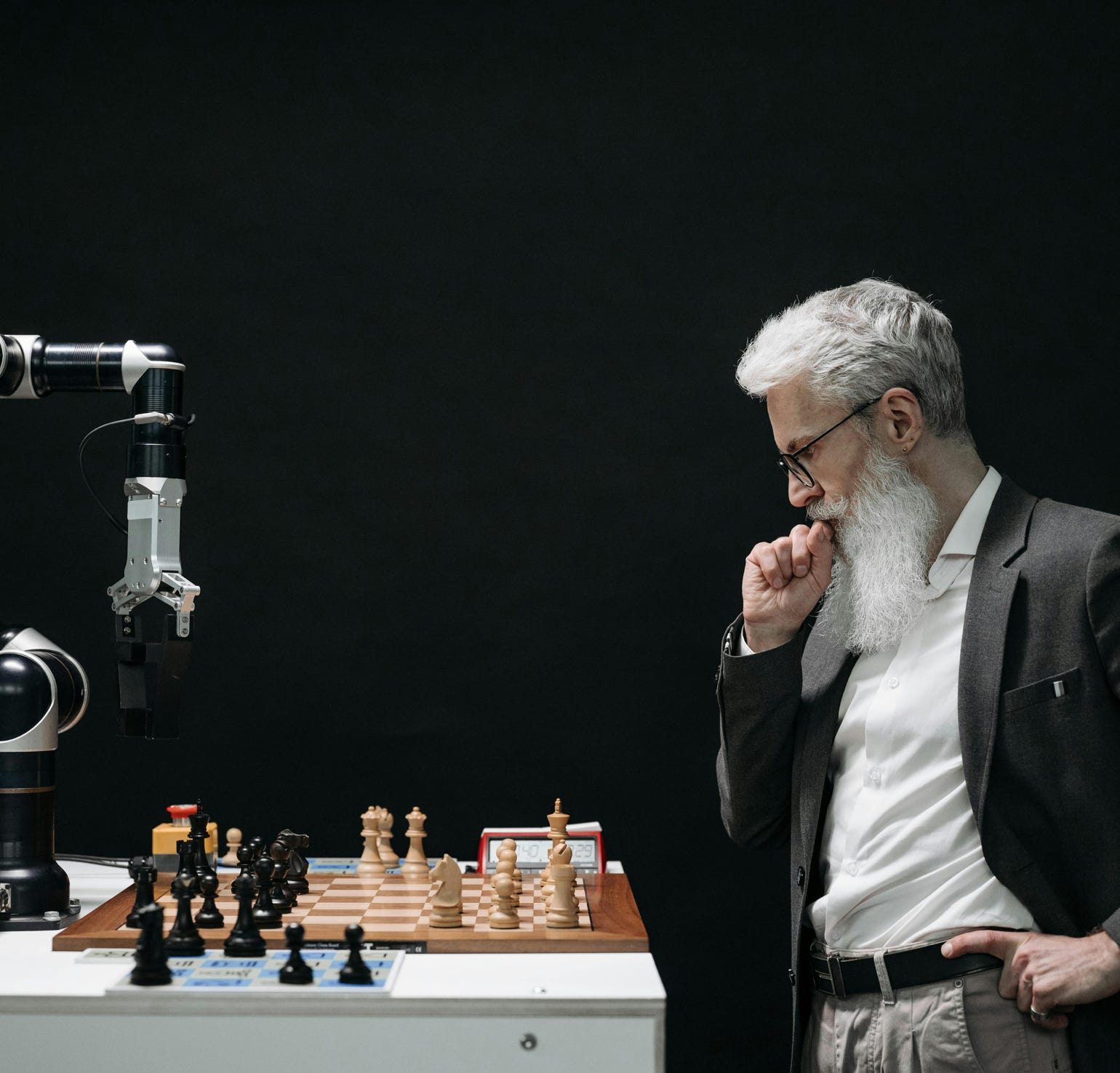 Elderly Man Thinking while Looking at a Chessboard